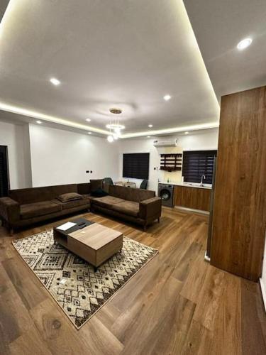 a living room with a couch and a table at Fully Furnished 1 Bedroom House in Accra
