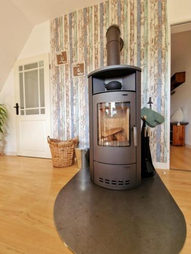 a stove sitting in a living room with a floor at Fewo NATURgeTREU in Medebach