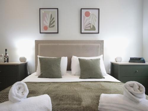 a bedroom with a bed with towels on it at Apartment 6 Old Conservative Club in Historic Town Pass the Keys in Caernarfon