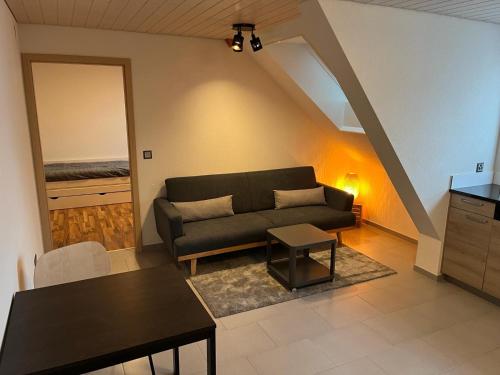 a living room with a couch and a table at Magnifique appartement de vacances "La Poste" in Saignelégier