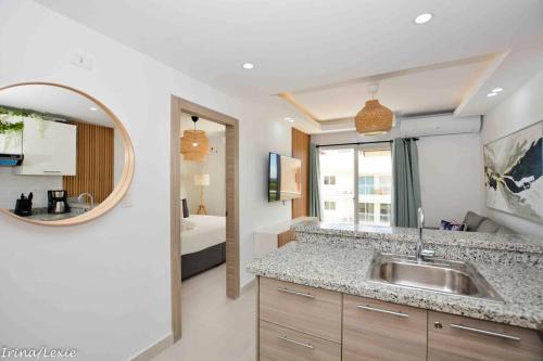 a bathroom with a sink and a mirror and a bed at Full CozyCondo+Private Terrace+BBQ in Punta Cana