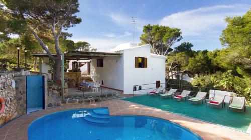 a villa with a swimming pool and a house at CAN BIEL in Cala Morell