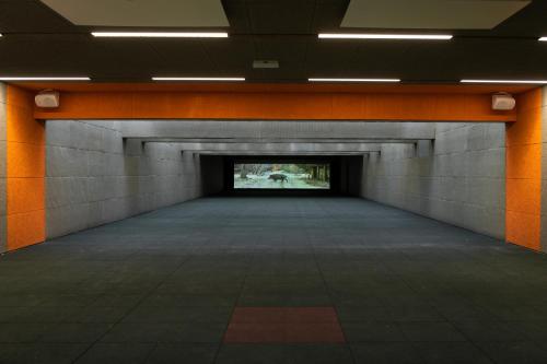 an empty hallway with orange walls and a tunnel at TARGET WORLD Hunter's Lodge in Landscheid