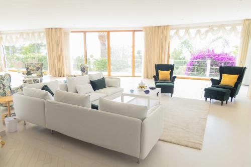 a living room with a white couch and chairs at La Canostra Capri - luxury ROOM ad Anacapri in Anacapri