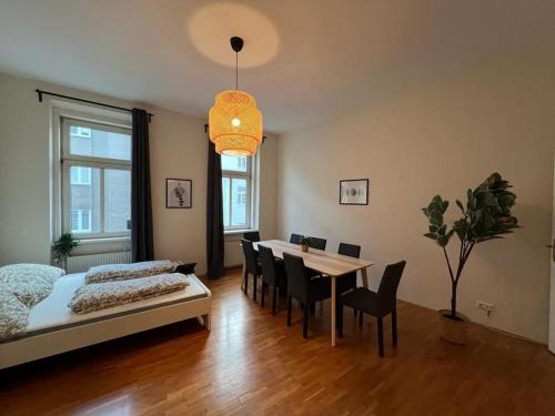 a bedroom with a bed and a table and chairs at 90 m2 Spacious Apartment - 15 min to Center in Vienna