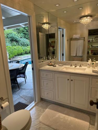 a bathroom with a sink and a large mirror at Luxury guest suite in Beverly Hills in Beverly Hills