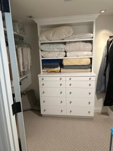 a closet with a white dresser and towels at Luxury guest suite in Beverly Hills in Beverly Hills