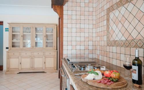 a kitchen with a sink and a counter with fruits and vegetables at La Canostra Capri - luxury ROOM ad Anacapri in Anacapri