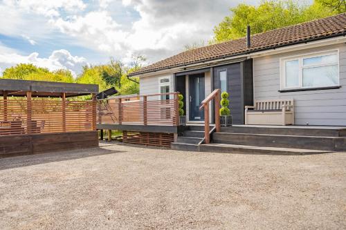 a house with a deck and a fence at Stone's Throw Away from the English Channel! -Family and Dog Friendly in Wootton