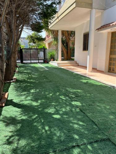 a yard with green grass in front of a house at Villa Maria Palese in Bari