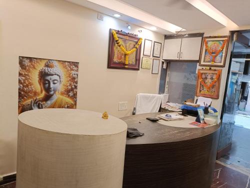 an office with a desk with a painting on the wall at Hotel Dakshin Sea Paradise in Visakhapatnam