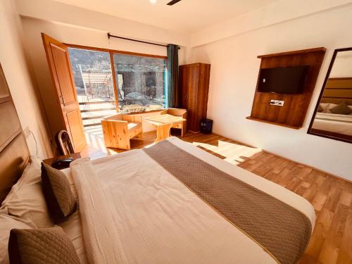 a bedroom with a bed and a large window at Solank Hotel & Cafe in Amritsar