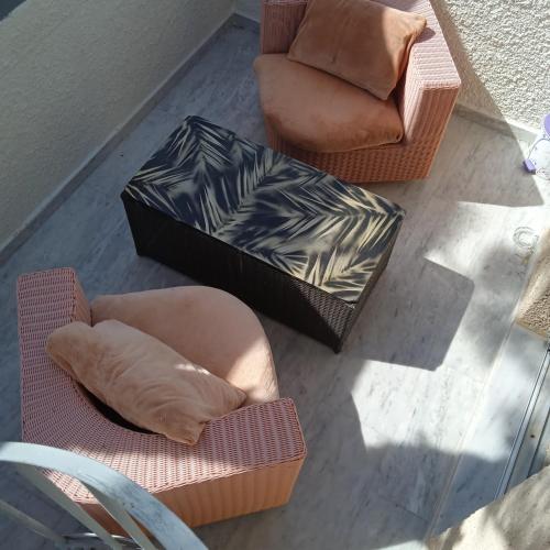 a living room with two chairs and a couch at The Best in Perissa