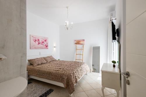 a small bedroom with a bed and a bathroom at Lydia's East Apartment in Aliki