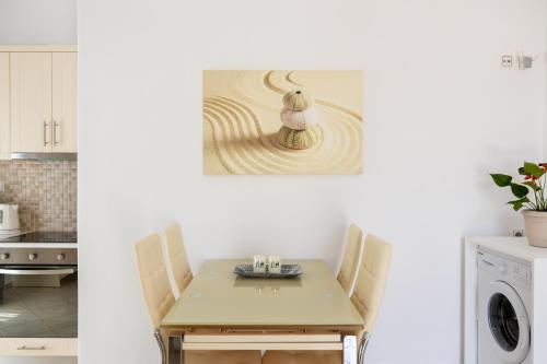 a table and chairs in a kitchen with a sink at Lydia's East Apartment in Aliki
