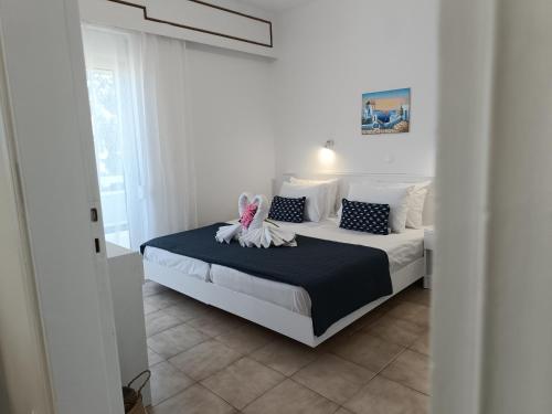 a bedroom with a bed with a stuffed animal on it at Nautilus City Studios & Apartments in Rhodes Town