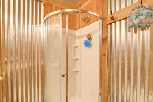 a shower in a bathroom with wooden walls at Cozy Hiltons Apartment with Fireplace and River Access 