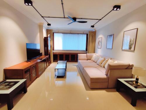 een woonkamer met een bank en een tv bij Wisma Cosway-2mins Pavillion & KLCC by Abby Stay in Kuala Lumpur