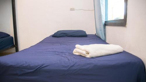 a white towel laying on a bed in a room at Casa Blanca - San Pedro in San Pedro La Laguna
