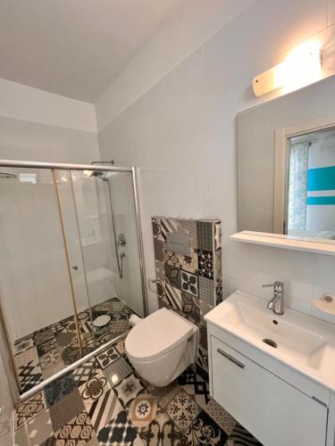 a bathroom with a toilet and a shower and a sink at The Best Apartment on the beach 'Caesar Beach' Bogaz, North Cyprus in Boghaz
