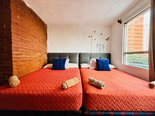 two beds sitting next to each other in a bedroom at NoMAD House in Guatemala