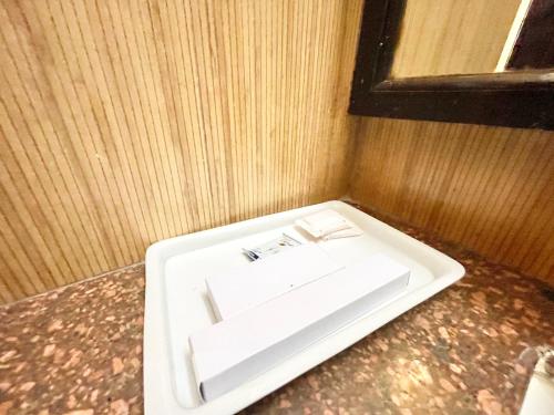 a white sink sitting on a counter in a room at HOTEL JANHVEE INN ! VARANASI - Forɘigner's Choice ! fully Air-Conditioned hotel with Parking availability, near Kashi Vishwanath Temple, and Ganga ghat in Varanasi