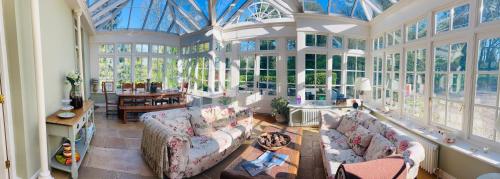 a large living room with large windows and couches at Larchmount House B&B in Derry Londonderry