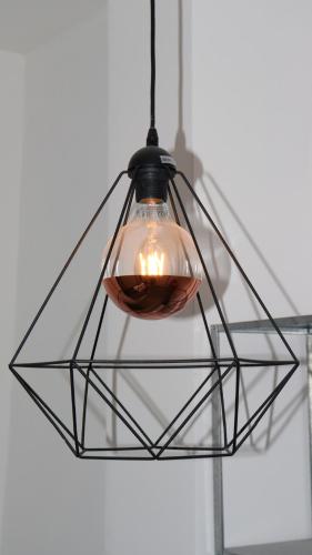 aendant light hanging from a ceiling at Apartmán - Café Princ pod Hradem WiFi, KLIMA in Šternberk