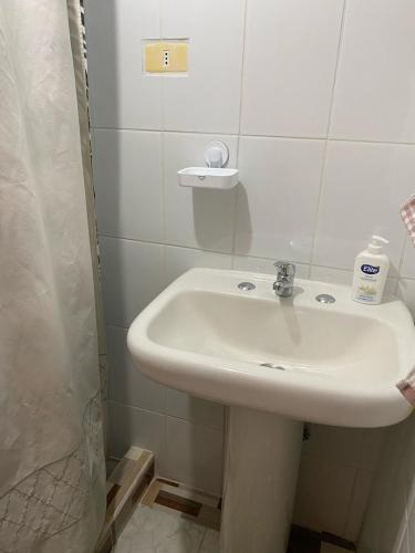 a bathroom with a white sink and a shower at Estrella Ancestral 1 in San Pedro de Atacama