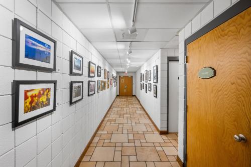 a hallway with pictures on the walls and a door at The Fountain Inn in Lakeside