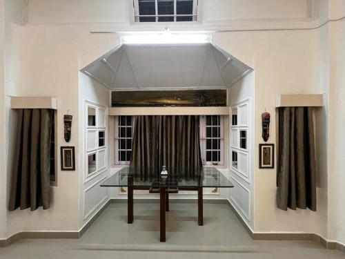 a glass table in a room with a window at Palm715 Villa in jorhat in Jorhāt