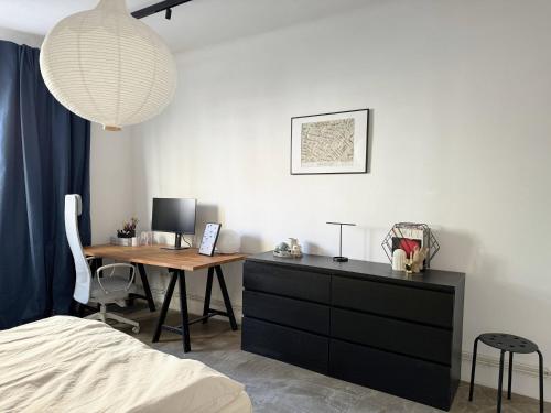 a bedroom with a desk and a table with a computer at Studio G06 in Zagreb