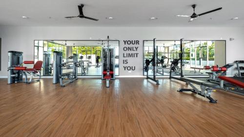 a gym with treadmills and machines in a room at Mirzas Alanis in Sepang