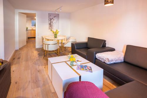 a living room with a couch and a table at Sope Skylodge 02 - Selina's & Gentjana's Kuckucksnest - Oberried, Schauinsland in Oberried