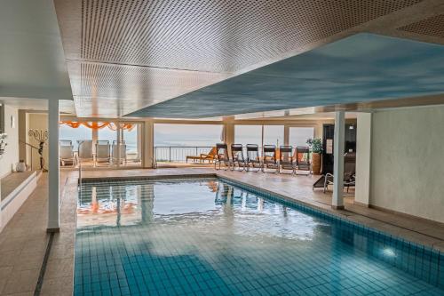 a swimming pool with a view of the ocean at Hotel Schönblick in Lochau