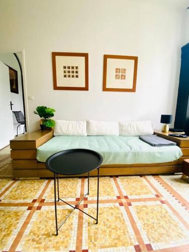 une chambre avec un lit et une table dedans dans l'établissement Maison Art Deco Calme en centre ville, à Limoges