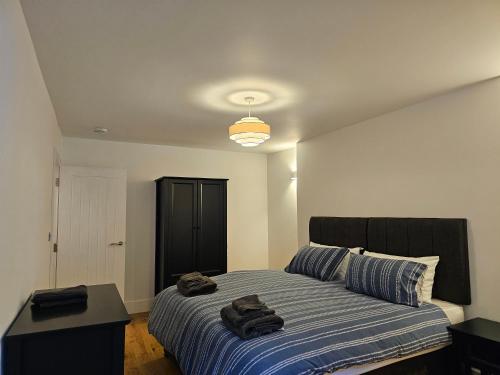 a bedroom with a bed with two towels on it at Spacious, modern 2-bedroom flat in Clifton in Bristol