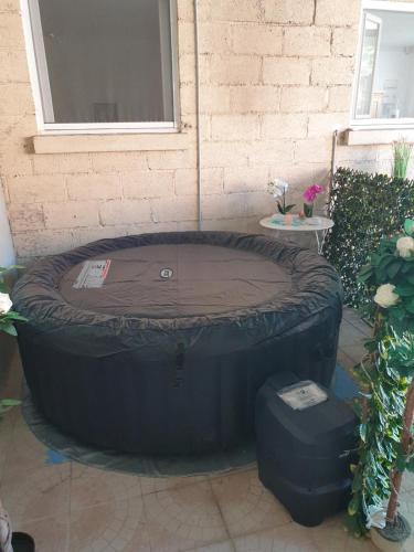 a large black tire sitting next to a building at FLORIDE in Le Mériot