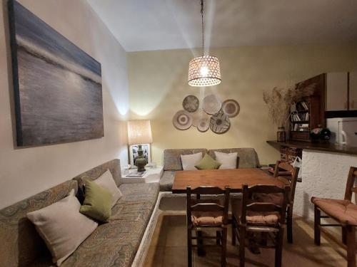 a living room with a couch and a dining room table at Poros Pine View in Poros
