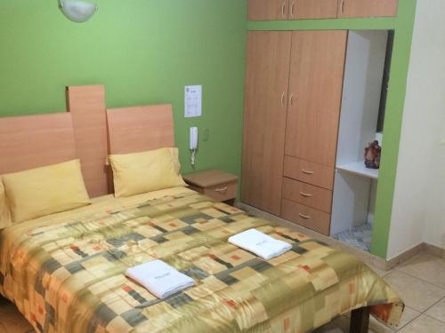 a bedroom with a bed with two laptops on it at Hotel Misky Samay in Ayacucho