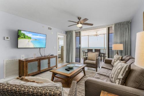 a living room with a couch and a tv at Fantastic Gulf Front Condo on the North End of the Island - Beach Villas # 504 condo in Fort Myers Beach