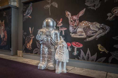 a statue of a man in an astronaut suit in front of a wall at Hotel & Gasthaus Löwen in Waldkirch