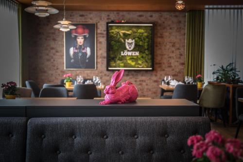 a pink stuffed bunny sitting on a table in a restaurant at Hotel & Gasthaus Löwen in Waldkirch