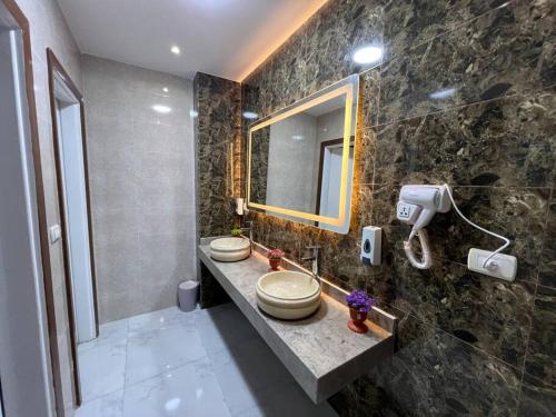 a bathroom with two sinks and a mirror at Luxury apartment Downtown Cairo in Cairo