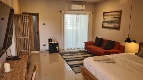 a living room with a bed and a couch at VNL Stay in Trang