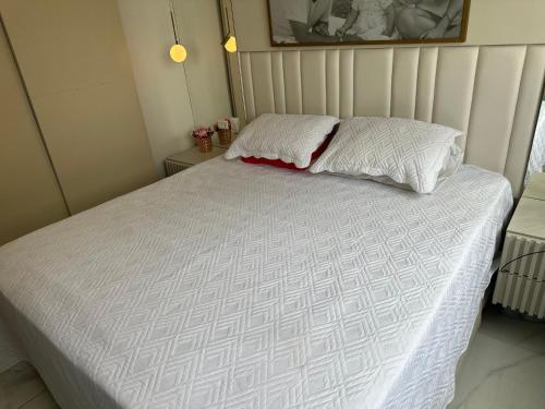 a bedroom with a bed with a white comforter at Casa para Carnaval in Recife