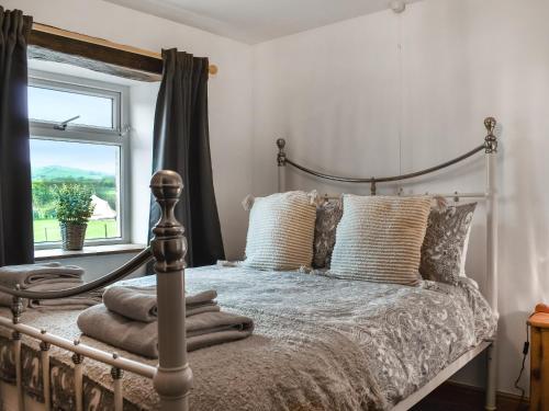 a bedroom with a bed with pillows and a window at New House Farm - Ukc6912 in Leck