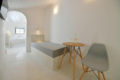 a bedroom with a bed and a table and a chair at Abri Hydra in Hydra