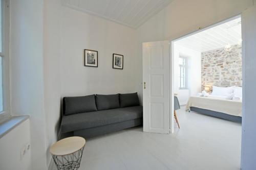 a living room with a couch and a bed at Abri Hydra in Hydra