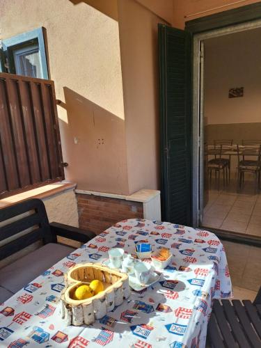 a table with a basket of bananas on top of it at Holidays at the Dock - Fiumicino Airport in Fiumicino